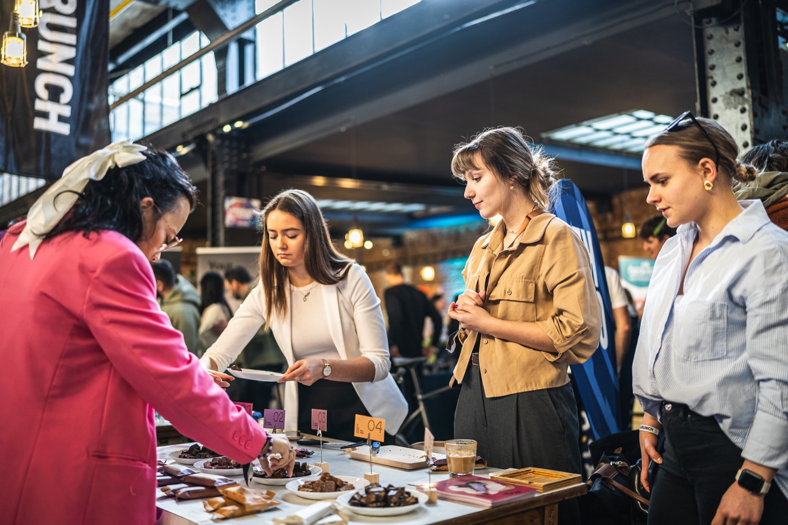 Visitors at a tasting session at an exhibition stand
