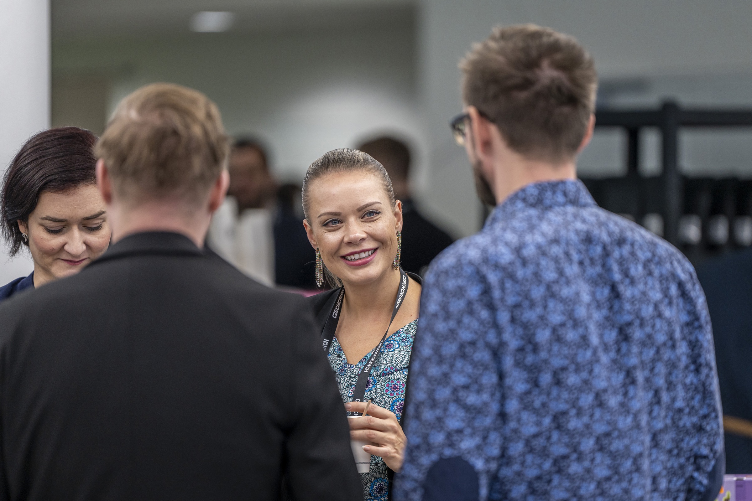 A smiling attendee in conversation at a business event